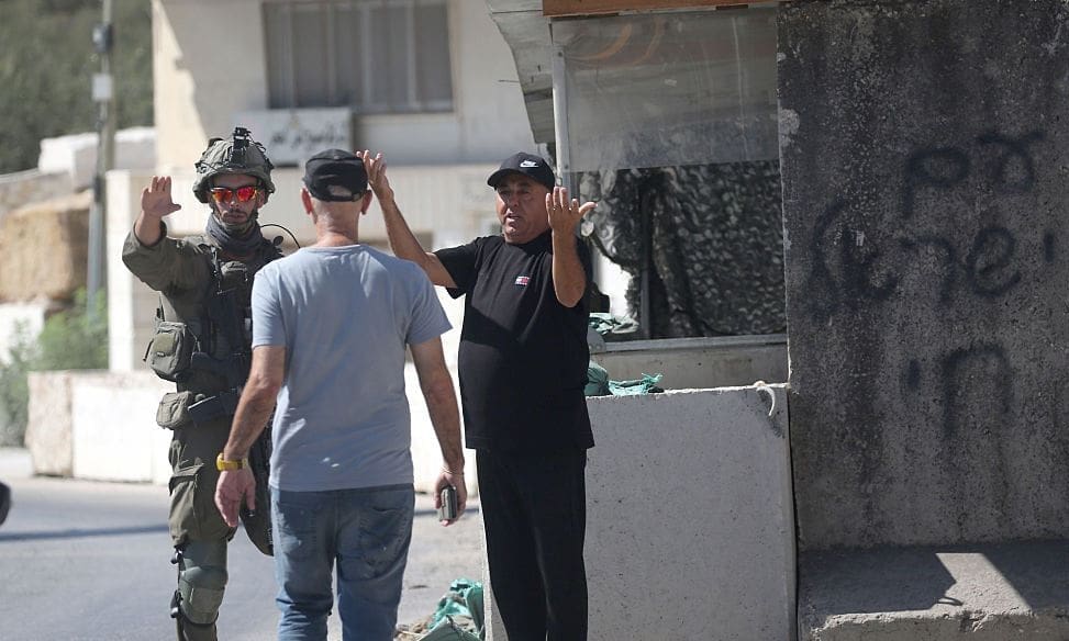 JENIN, PALESTINE - 2026/09/20: Israeli soldiers seen preventing a Palestinian from passing through a military checkpoint following a car-ramming attack carried out by a Palestinian near an Israeli military base south of the city of Jenin. Israeli troops fired upon a Palestinian vehicle east of Jenin, killing one occupant and wounding a second following an alleged car-ramming attempt near a military post. Following the fatal incident, the Israeli army established a security cordon and blocked main transit routes connecting Jenin to surrounding areas.