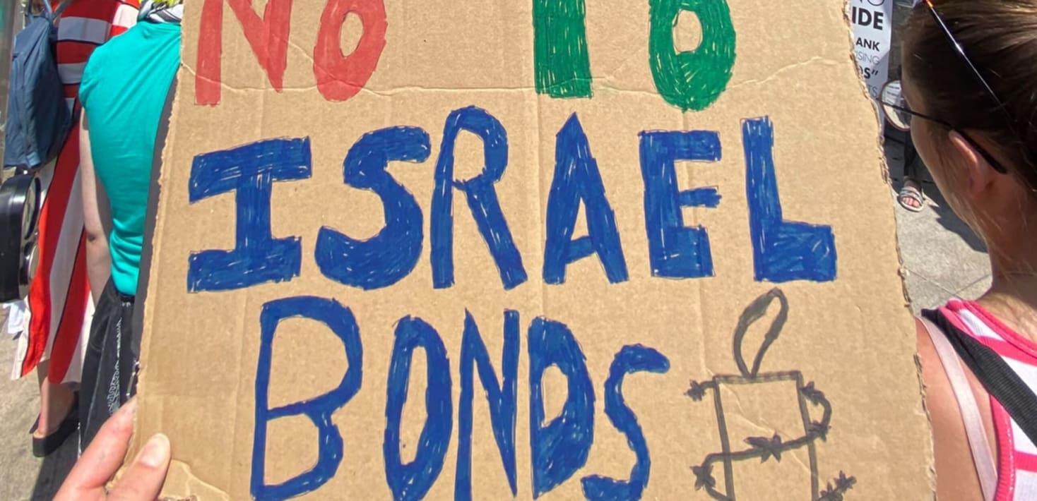 Protester holds up placard that says 