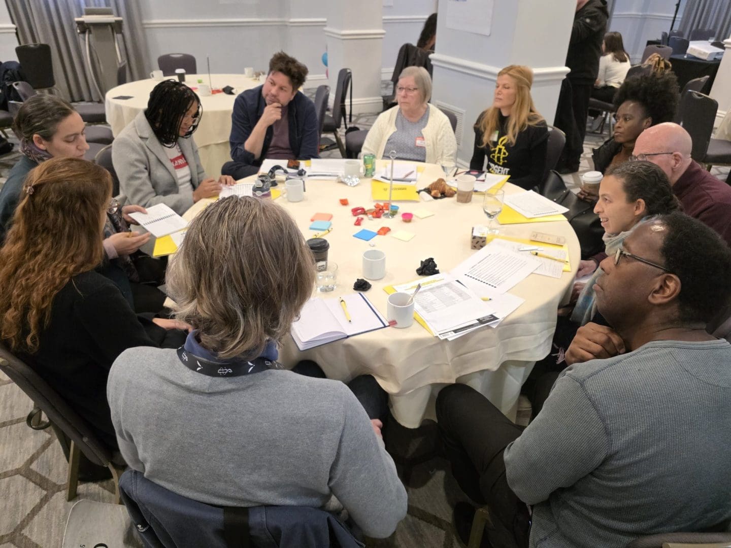people around a round table with a white tablecloth
