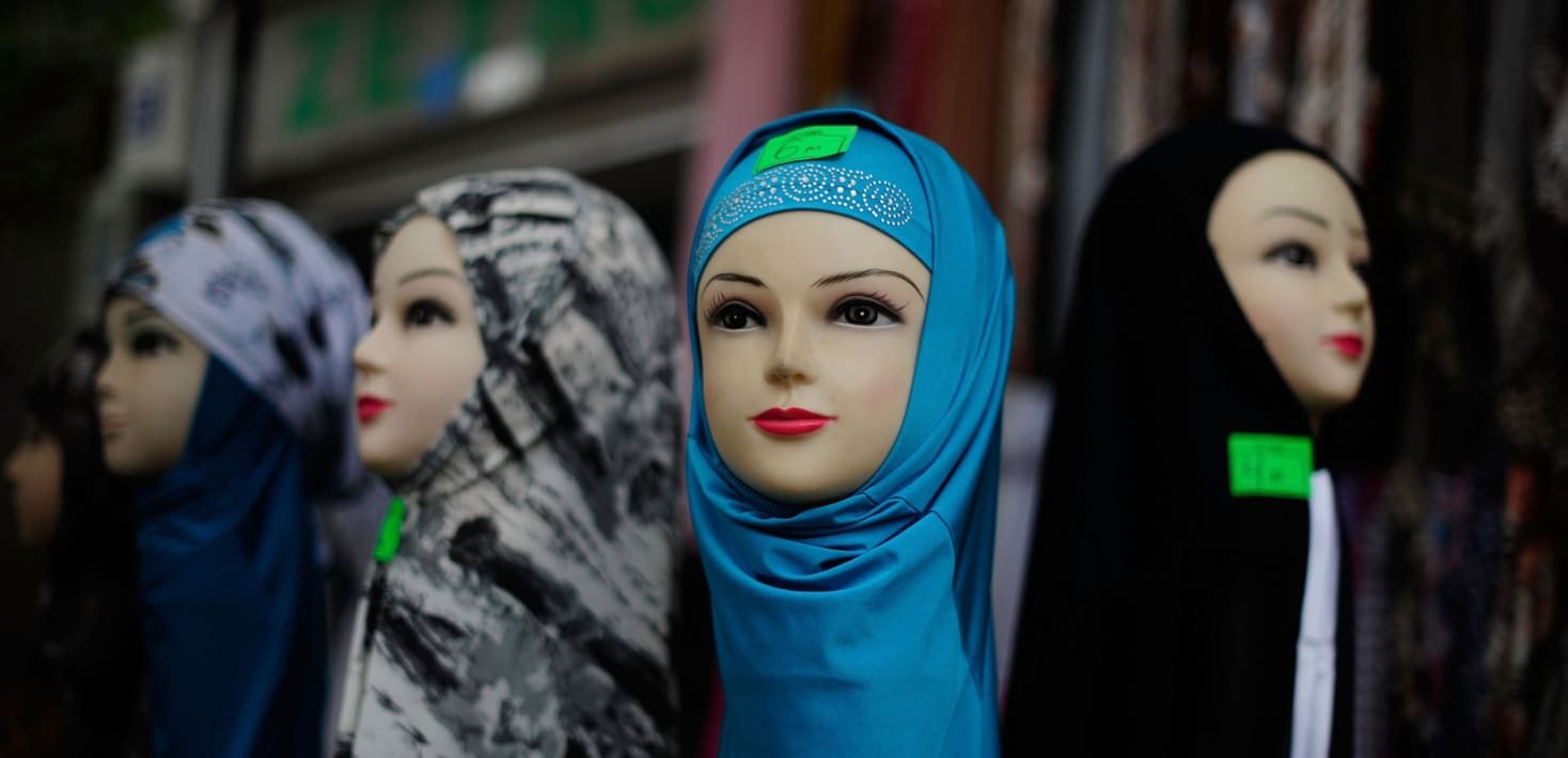 Four female mannequin heads wearing hijab.