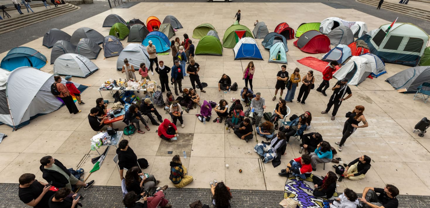 A group of people sitting around tents
